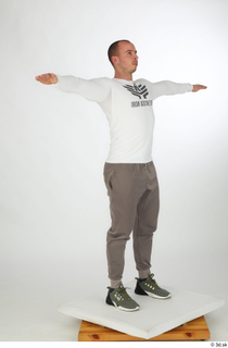 Joel dressed green sneakers grey jogger pants sports standing t-pose…